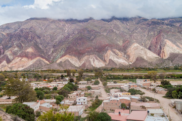 Village Maimara under colorful rock called Paleta del Pintor (Painter's Palette) in Quebrada de Humahuaca valley, Argentina