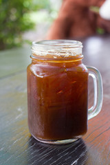 Iced Americano on wood table.
