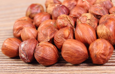 Heap of brown hazelnut on wooden table