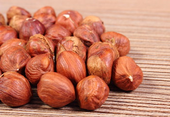 Heap of brown hazelnut on wooden table
