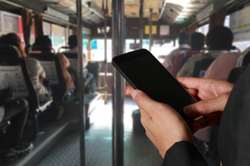 Woman hand hold and touch screen smart phone, tablet,cellphone on blurred abstract in the bus...