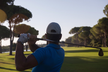 golf player hitting shot