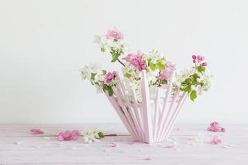 Beautiful ripe apples and branches in vase on white