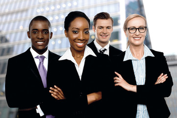 Group of office workers staying in front of modern building