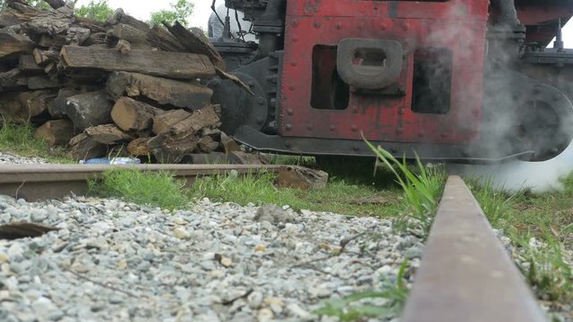 Rail ground view of a parked steam vintage locomotive.