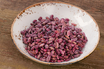 Beans in a bowl on wooden table