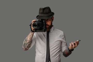 A man with dslr isolated on grey background.