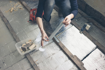 Young woman insulating floor