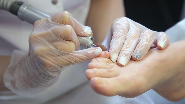 Woman gets a pedicure procedure in spa salon