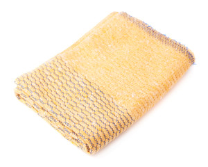 Folded yellow towel isolated over the white background