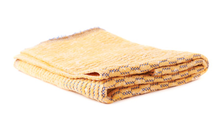 Folded yellow towel isolated over the white background