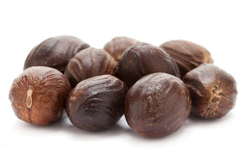 Mature Organic Nutmeg (Myristica fragrans) isolated on white background. Macro closeup Front view.