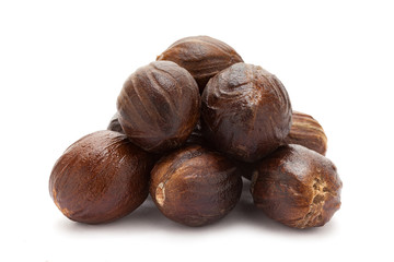 Mature Organic Nutmeg (Myristica fragrans) isolated on white background. Macro closeup Front view.