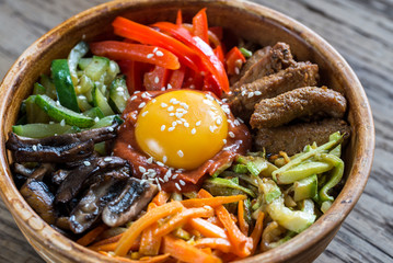 Bowl of bibimbap on the wooden table