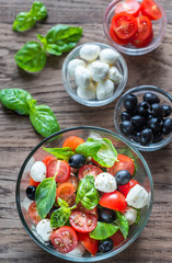 Salad with tomatoes, olives, mozzarella and basil