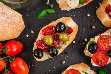 Bruschettas with tomatoes, herbs and olives