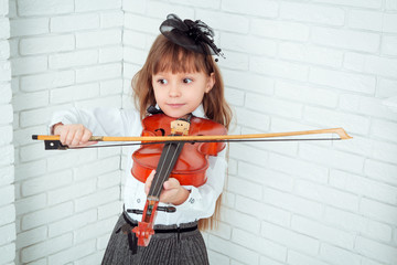 little girl playing the violin © monochromst