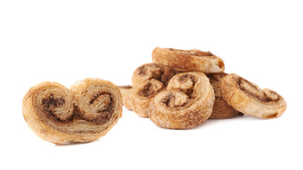 Single cookie next to Pile of cookies isolated over the white background