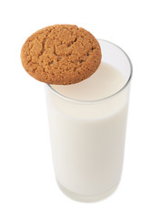 Glass of milk and cookie isolated over the white background
