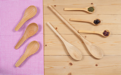 Tablecloth, wooden spoon, on wood textured background