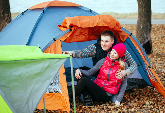 Couple camping. Young couple sitting near the tent.