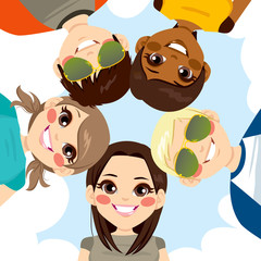 Five happy young smiling teenagers forming a circle together from low angle view