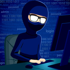 Hacker man typing on computer breaking system security code wearing balaclava and dark clothing to conceal his identity