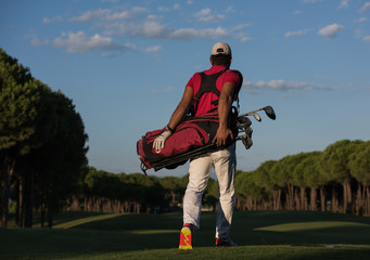 golfer  walking and carrying golf  bag