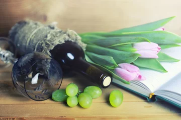Foto op Plexiglas wooden table with wine bottle book and grape © alexkich