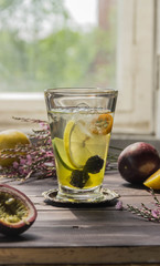 Cocktail of lime, lemon,kumquat,blackberries with ice
