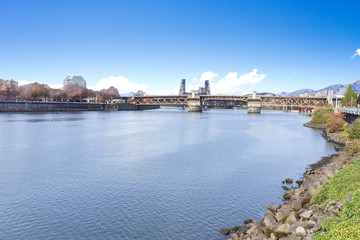 Fototapeta na wymiar bridge over water with cityscape and skyline of portland