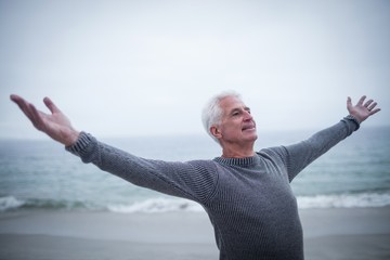 Senior man with arms outstretched