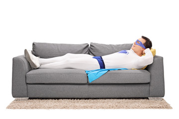 Young superhero sleeping on a couch © Ljupco Smokovski