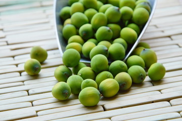 lotus seed in iron scoop on bamboo plate