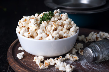 Popcorn in  bowl over wooden background