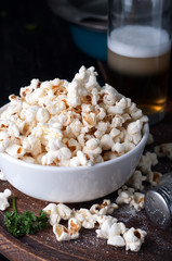 Popcorn in  bowl over wooden background