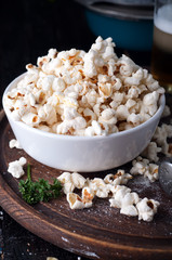 Popcorn in  bowl over wooden background