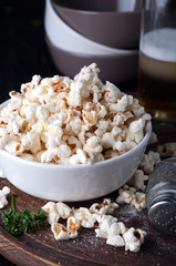 Popcorn in  bowl over wooden background