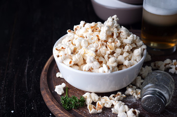 Popcorn in  bowl over wooden background
