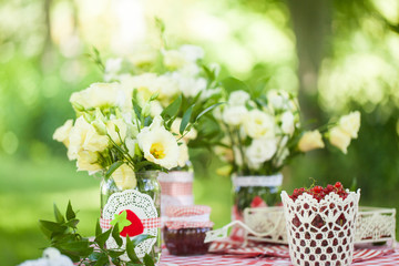 Summer table with flowers and berries