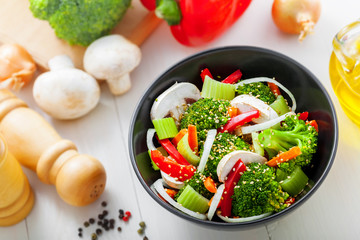 Bowl of delicious salad made of vegetables.  Healthy vegetarian food. Top view.