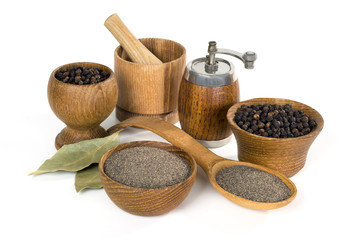 black pepper and wooden utensils on white background
