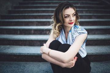 Fototapeta premium interesting young lady sitting on stairs