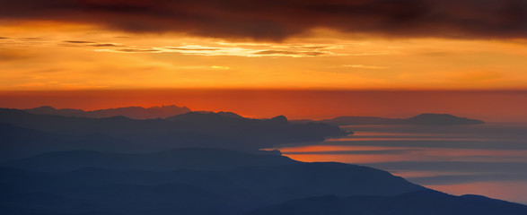 Dramatic sunrise in mountain. A panoramic image of the eastern part of Crimean mountains.