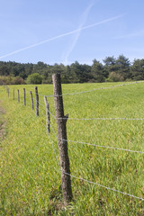 farm borders with barbed wire fence 