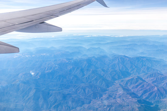 Fototapeta landscape of mountains through window of airplane