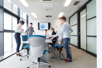 business people group entering meeting room, motion blur