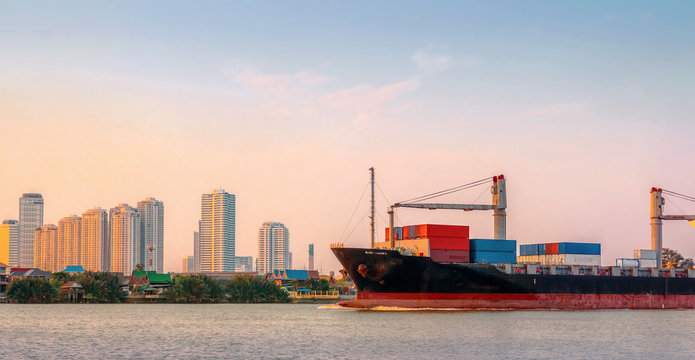 Cargo ship was sailing from the river toward the Gulf of Thailand in the evening.