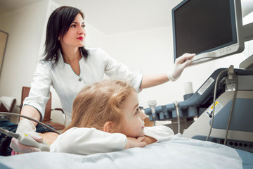 Doctor and little girl patient. Ultrasound equipment.