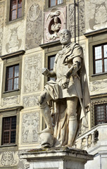 Obraz premium Grand Duke of Tuscany Cosimo I subduing a dolphin, symbol of domination over the seas. A statue in front of Palazzo della Carovana in Pisa Knight's Square, made by artist Pietro Francavilla in 1596